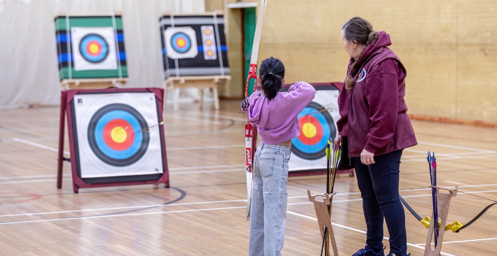 Trying archery at Waterbeach Health and Wellbeing day