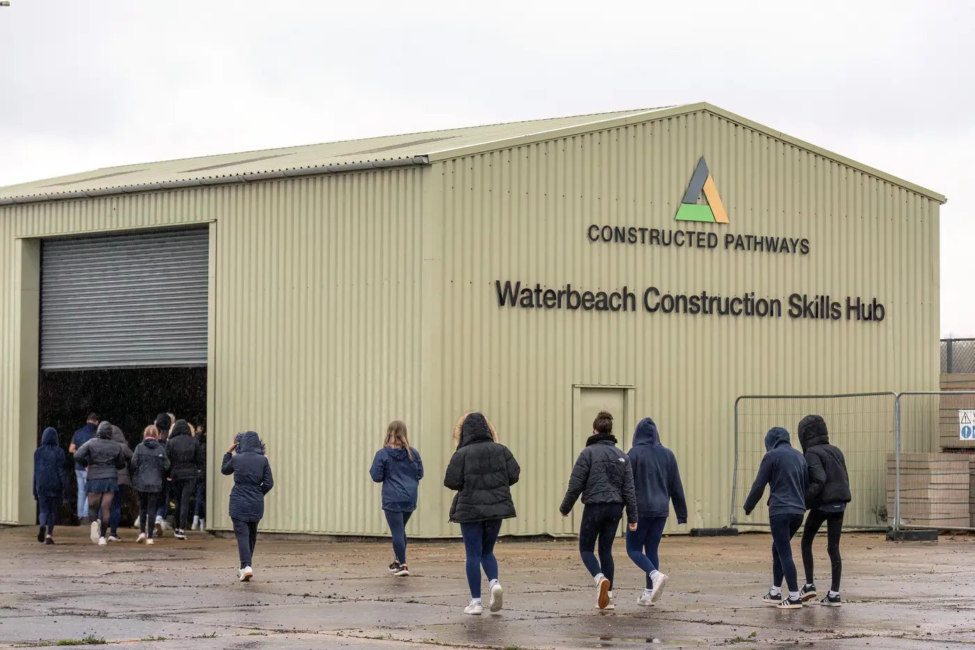 Image of students walking into Waterbeach Construction Site Hub
