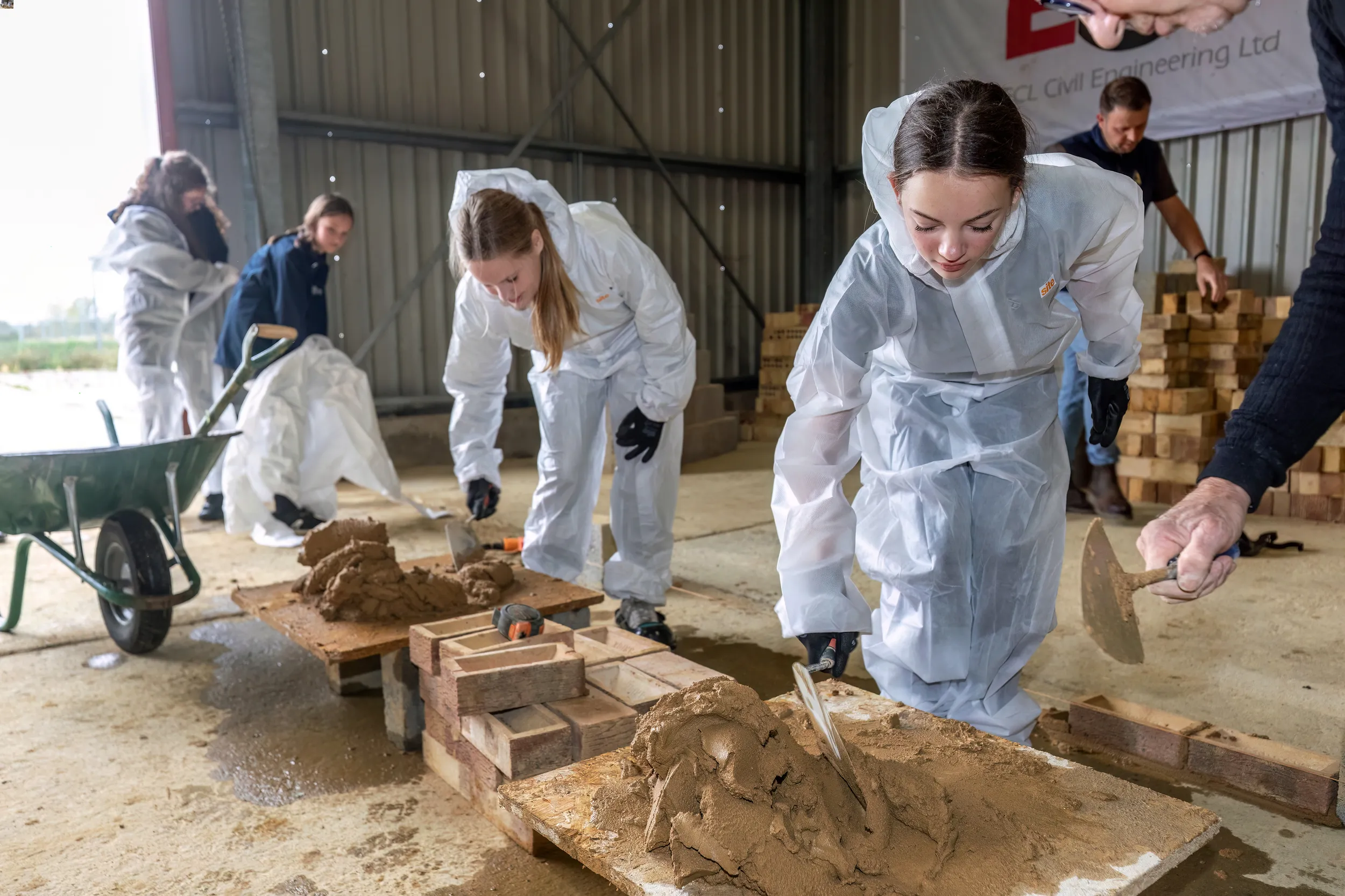 Girls learning to brick lay