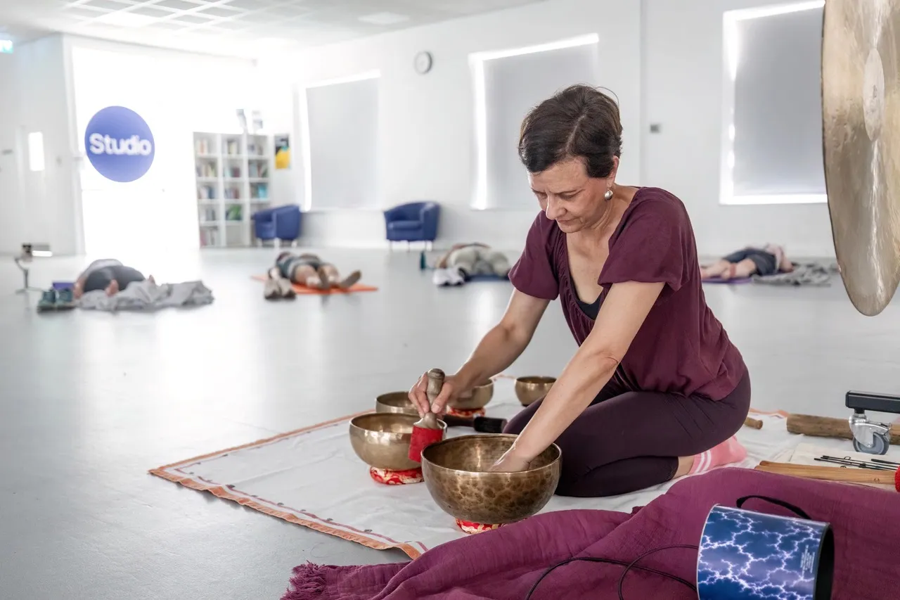 A lady doing a soundbath