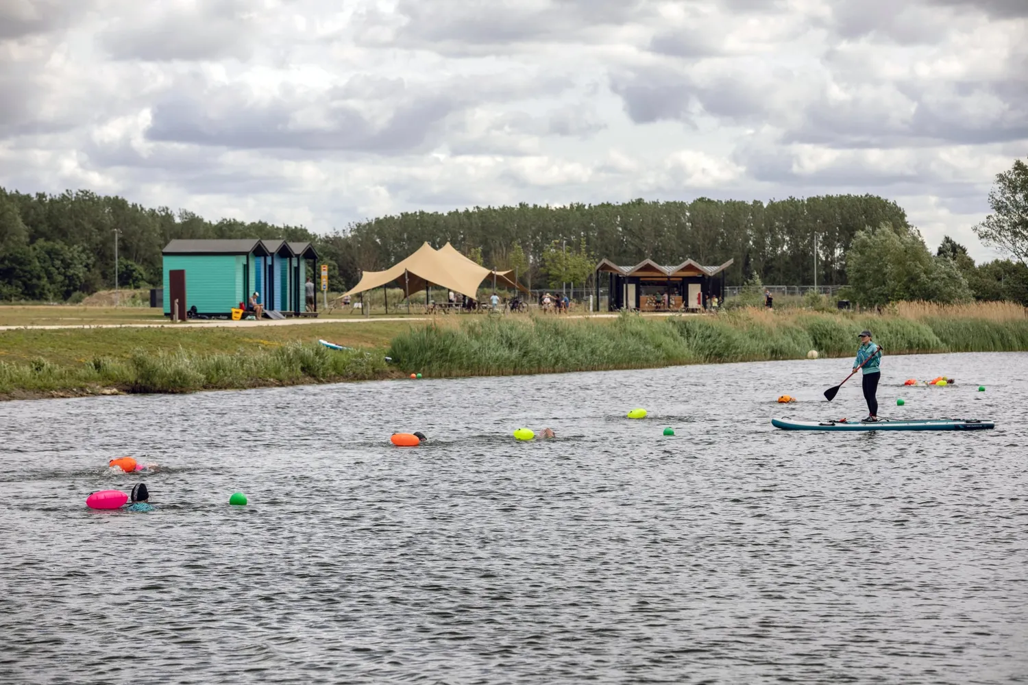 A person paddle boarding at Waterbeach lake